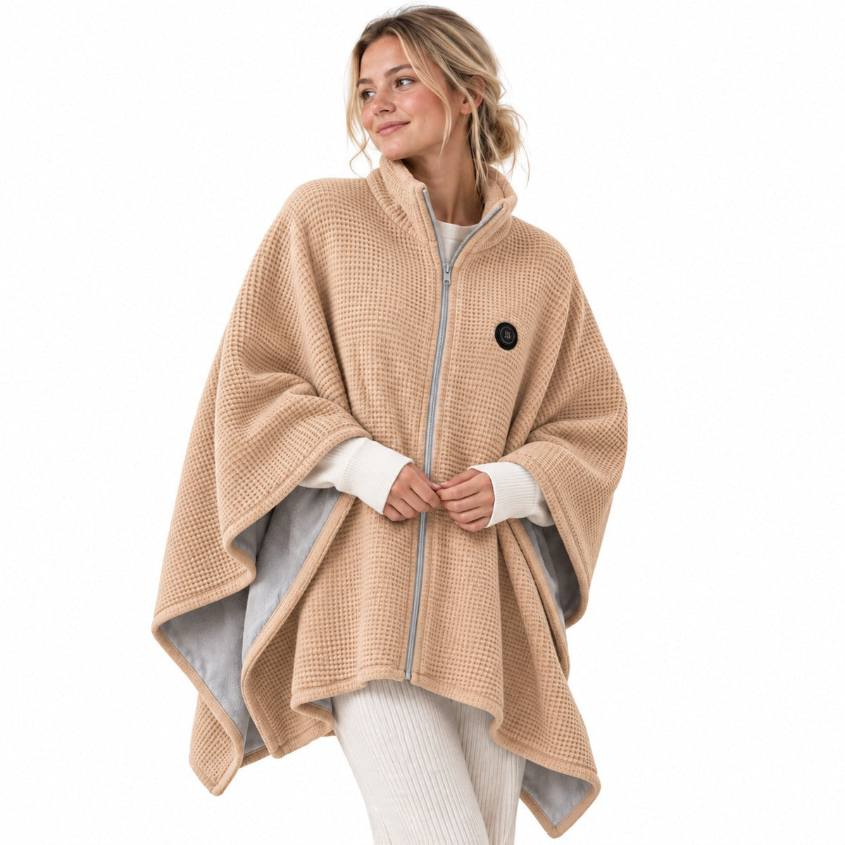 Model wearing a beige USB heated shawl with a zip front